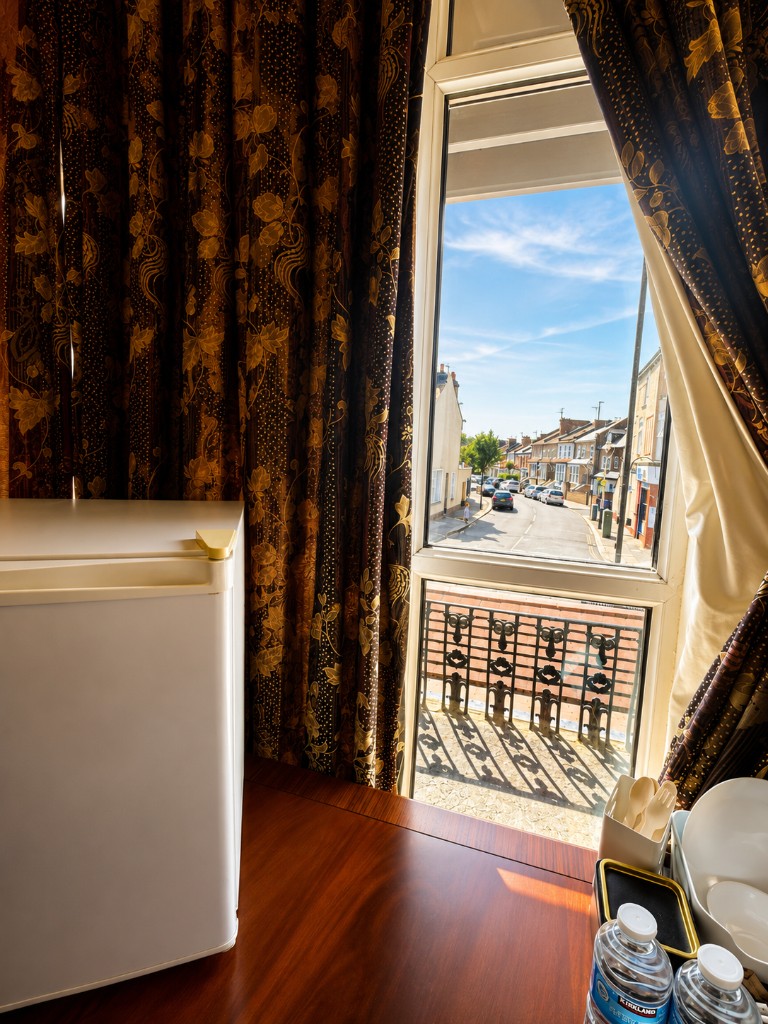 Room window view with mini fridge and refreshments